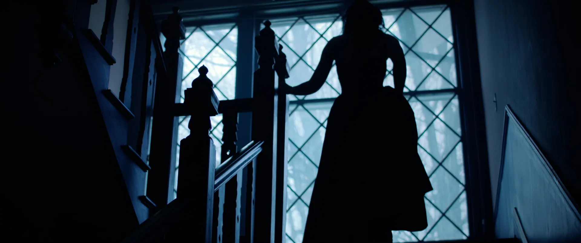 Silhouettes on a stained glass staircase